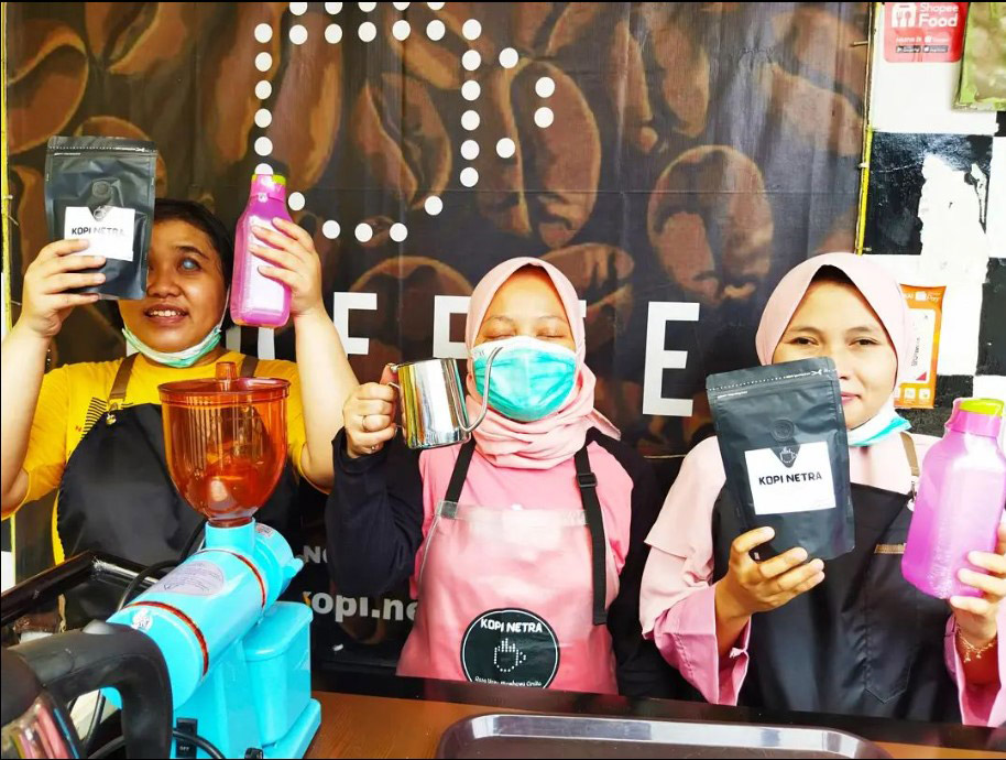 A picture of Restiawati, a visually-impaired entrepreneur whose business has flourished under the mentorship and guidance of the Maybank R.I.S.E. programme, flanked by two of her visually-impaired employees.