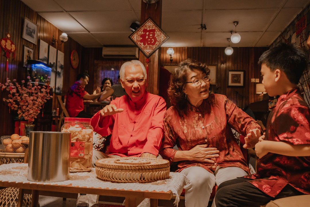 Grandparents with grandson, celebrating Chinese New Year
