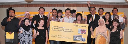 Maybank Executive Vice President & Head of Cards and Unsecured Lending, Mr B Ravintharan (in yellow tie) with some of the winners of the Maybankard MasterCard Platinum Debit Campaign.